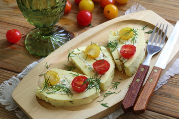 Omelette roll stuffed with cheese with garlic and herbs and a glass of wine