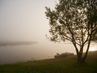 Fototapeta na wymiar fishing on an early foggy morning boat on the water