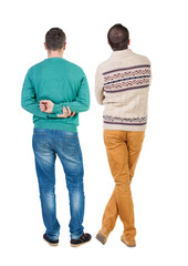 Back view of two man in sweater pointing.