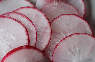 slices of juicy radish on a plate macro photo