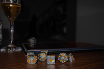 D20 Dungeon and dragons dice on top of wooden table
