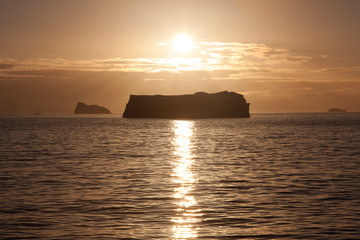Naklejka na ściany i meble Antarctica landscape with icebergs at sunset on a winter day
