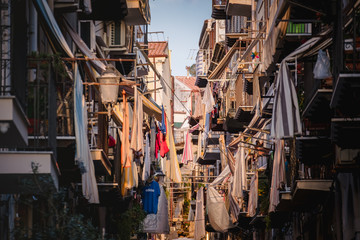Fototapeta na wymiar CEFALU, ITALY - October 02, 2019: Old town street with balconies and clothes
