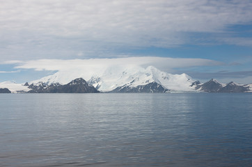Antarctica landscape with mountains and sea on a cloudy winter day