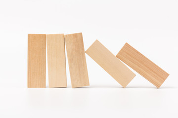 Domino effect, row of wood domino on white background