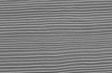 A fragment of old paint on a wooden board. Stripes, monochrome.