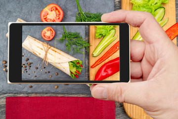 Vegetable roll on smartphone screen. Nutrition for healthy lifestyle.