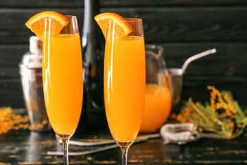 Glasses of tasty mimosa cocktail on table, closeup