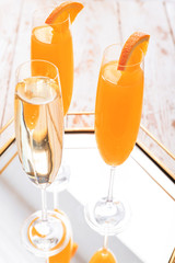 Glasses of tasty mimosa cocktail and champagne on table