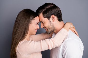 Closeup profile photo pretty adorable lady handsome guy tender look eyes leaning heads with love emotions stand close hugging wear shirt pullover isolated grey color background