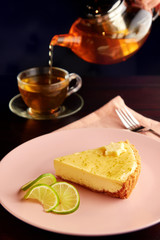 Piece of tart with lime zest and slice of limes.