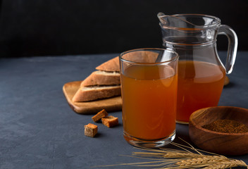 Kvass in a glass and a jug of rye bread