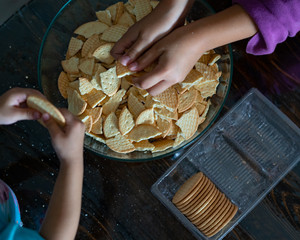 Kids making Kek Batik or Malaysian Triple Chocolate Dessert. Doing the initial steps, crushing the...