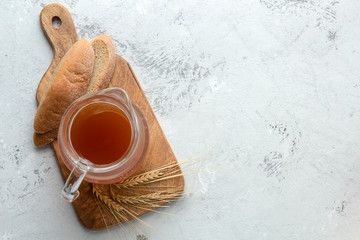 Jug with kvass soft drink on a light background