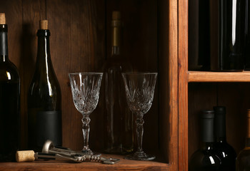 Bottles of wine and glasses in cellar