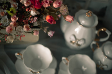 still life ceramic dishes with bow. flowes in a pot. Family photo frame.
