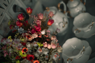 still life ceramic dishes with bow. flowes in a pot. Family photo frame.