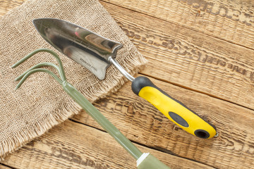 Garden tools on sackcloth and wooden boards.