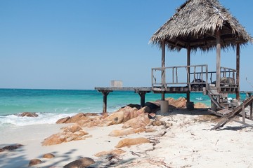 Wooden cabana with pier on paradise tropical beach. Koh Munnork beach front resort on private island, Rayong province, Thailand.
