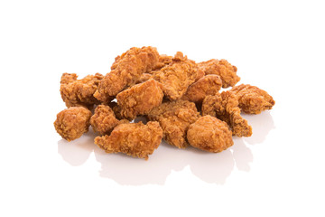 Fried chicken nuggets isolated on white background with reflection.