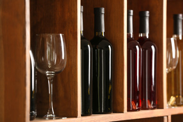 Bottles of wine and glass in cellar