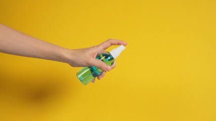 Hand is holding Alcohol Spray on white background.