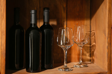 Bottles of wine and glasses in cellar