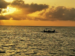 Small fishing boat at sunset.