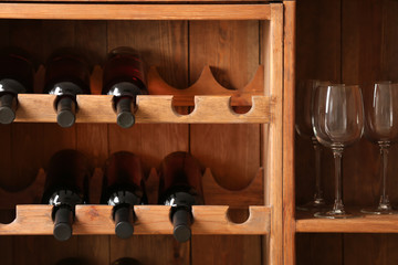 Bottles of wine and glasses in cellar