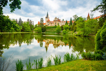 Fototapeta na wymiar Castle with reflection in pond in spring time in Pruhonice, Czech Republic
