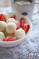 Table top view of coconut raw balls. Vegan raw balls. home made raw raffaello. Flat lay scene with coconut bark, milk and flour with pussy willow.