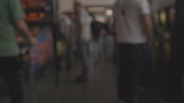 walking through busy arcade out of focus