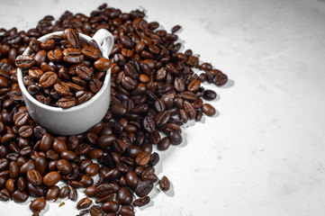 A cup of espresso with coffee beans on a white background