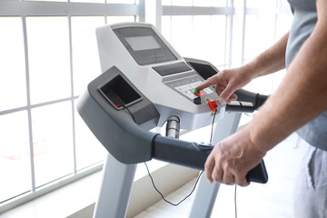 Obraz premium Senior man training on treadmill in gym