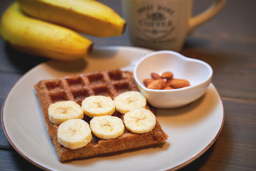 Belgian waffles with honey, banana, nuts and blueberries