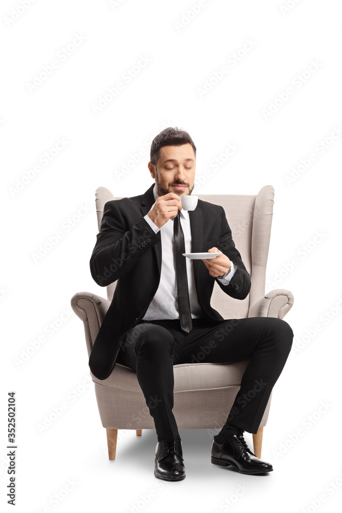 Poster businessman sitting in an armchair with a cup of espresso coffee