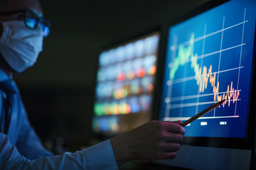 Businessman with computer at desk, working late. Financial crisis concept.
