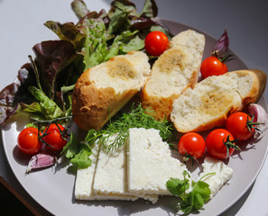 tomatoes, herbs, slices of cheese and garlic bread close-up