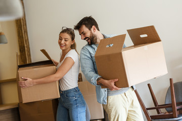 Young married couple moving into new home.	
