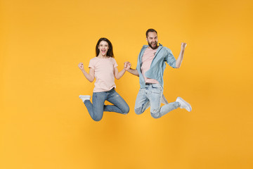 Joyful young couple two friends guy girl in pastel blue casual clothes posing isolated on yellow...