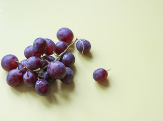 bunch of ripe grapes on a light background