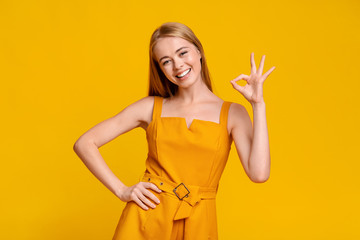 Offer For Teens. Positive Girl In Summer Dress Showing Ok Sign