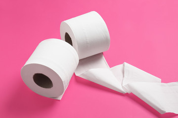 Rolls of toilet paper on color background