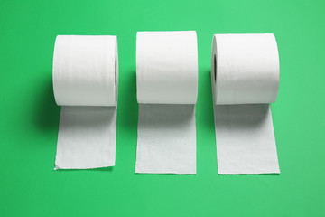 Rolls of toilet paper on color background
