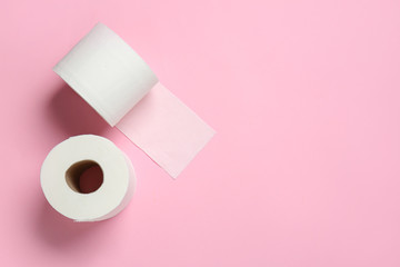 Rolls of toilet paper on color background