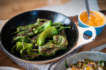 Close up of Padron peppers in a pan