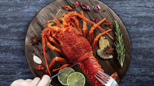 Cooked Boiled Lobster, Delicious Dinner Seafood Meal Set With Knife And Fork On Black Stone Slate Background, Restaurant Menu Design, Top View, Overhead