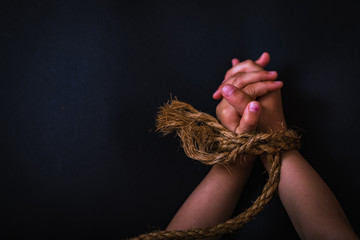 Girls hands were tied with a rope. Child bondage, violence, terrified. International human rights...