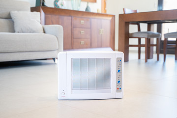 Ozone machine generator inside the living room floor. Home cleaning and disinfection during covid...