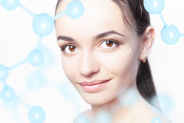 Beautiful model with cosmetic drops of moisturizing cream on her face and hyaluronic acid molecule...